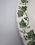 The Brooklyn Teacup Churchill Ivy oval serving platter with green botanical leaf pattern on white scalloped ceramic