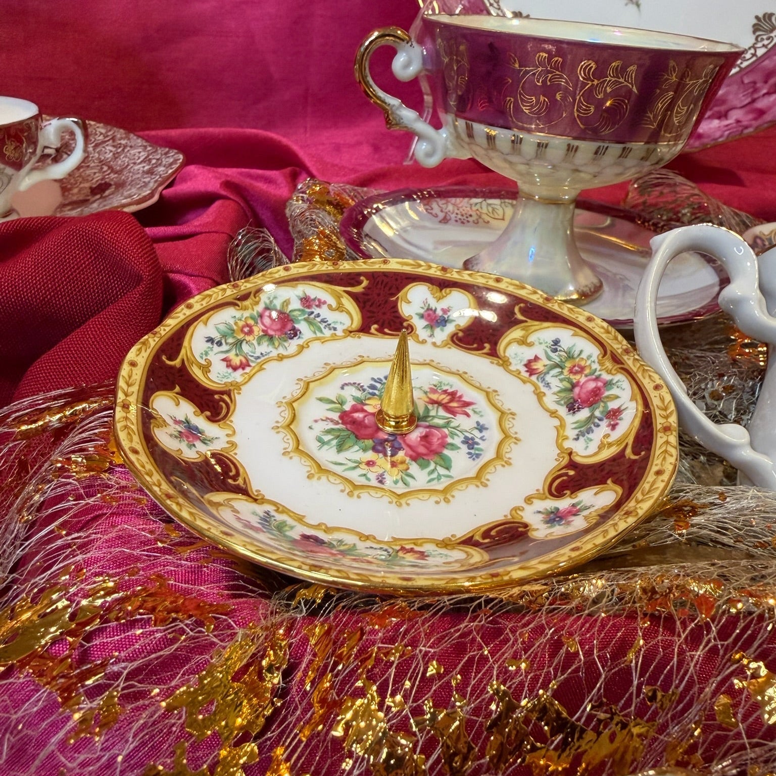 Regal-looking, richly saturated floral ring holder featuring Royal Albert’s Lady Hamilton pattern. Gold cone for stacking rings at the center.