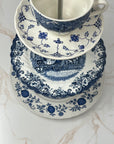 Close-up of eclectic blue and white china patterns on 3- tiered tray with silver T hardware