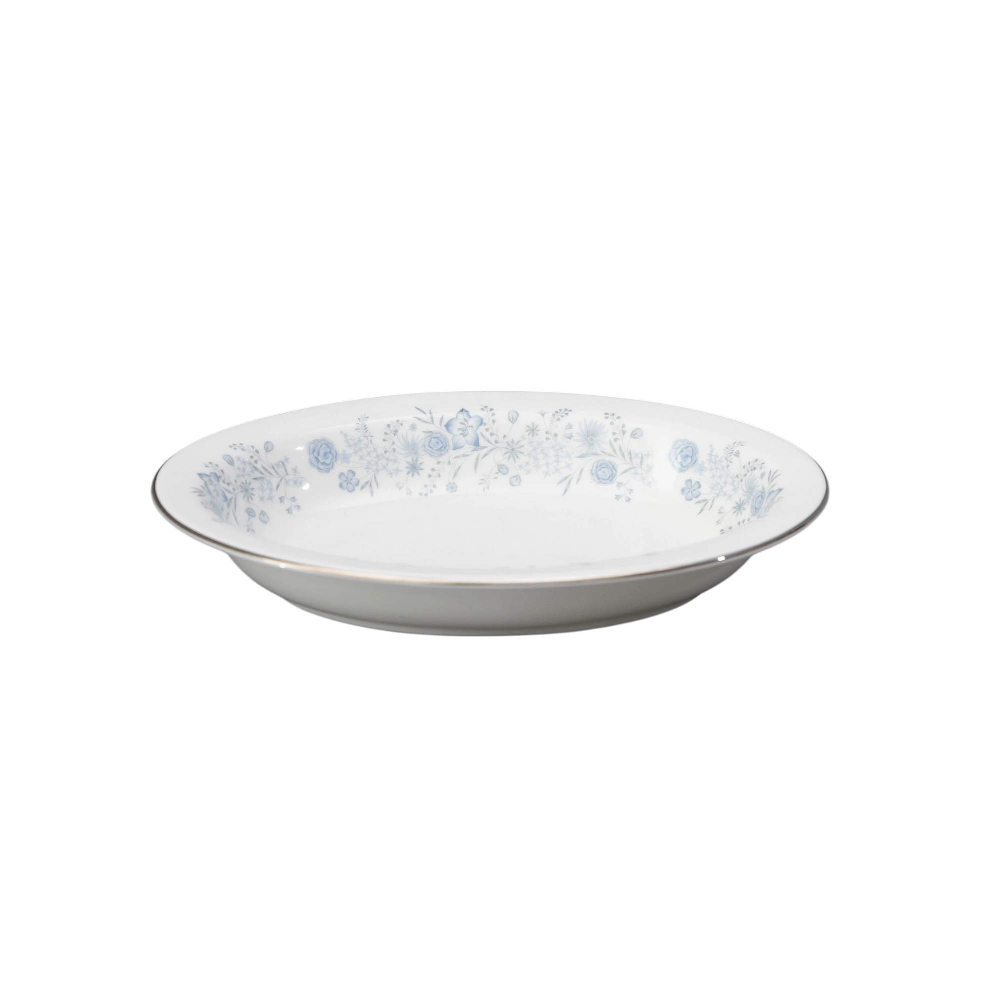 The Brooklyn Teacup oval serving bowl in white porcelain with a delicate blue floral pattern and silver rim.