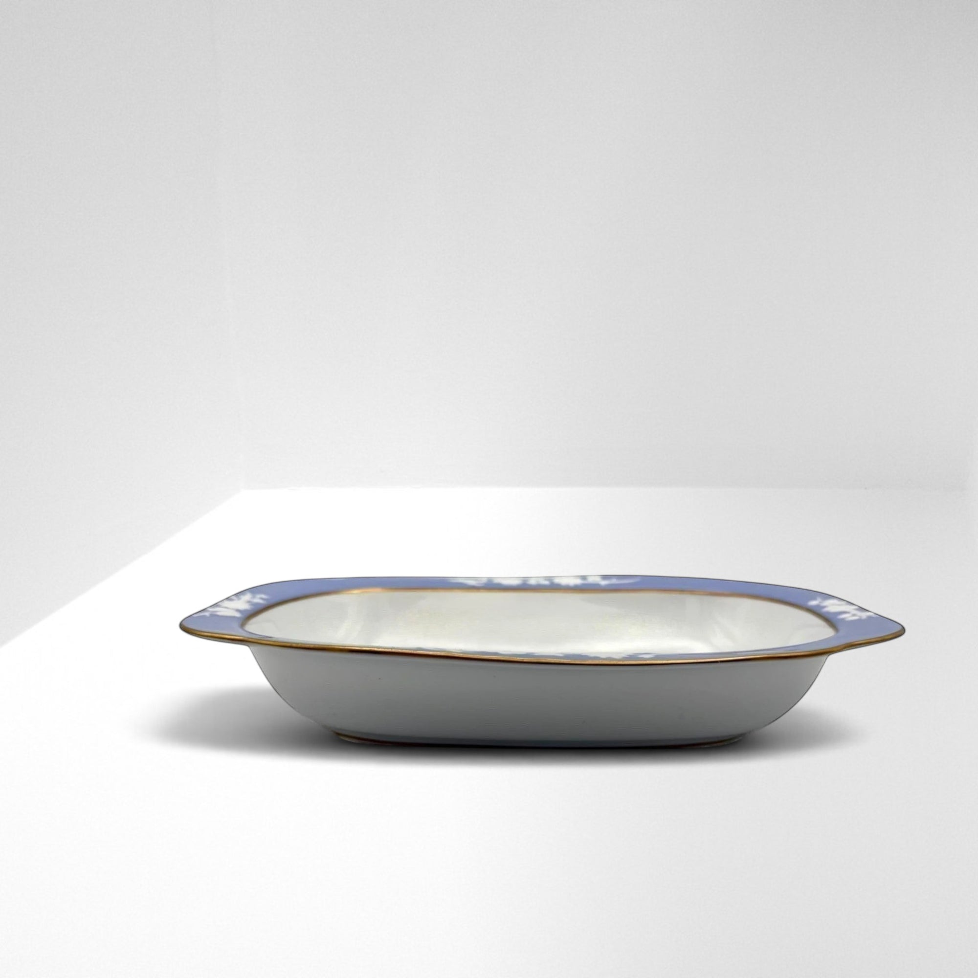 The Brooklyn Teacup oval serving bowl with blue floral pattern, white interior, and gold rim detail.
