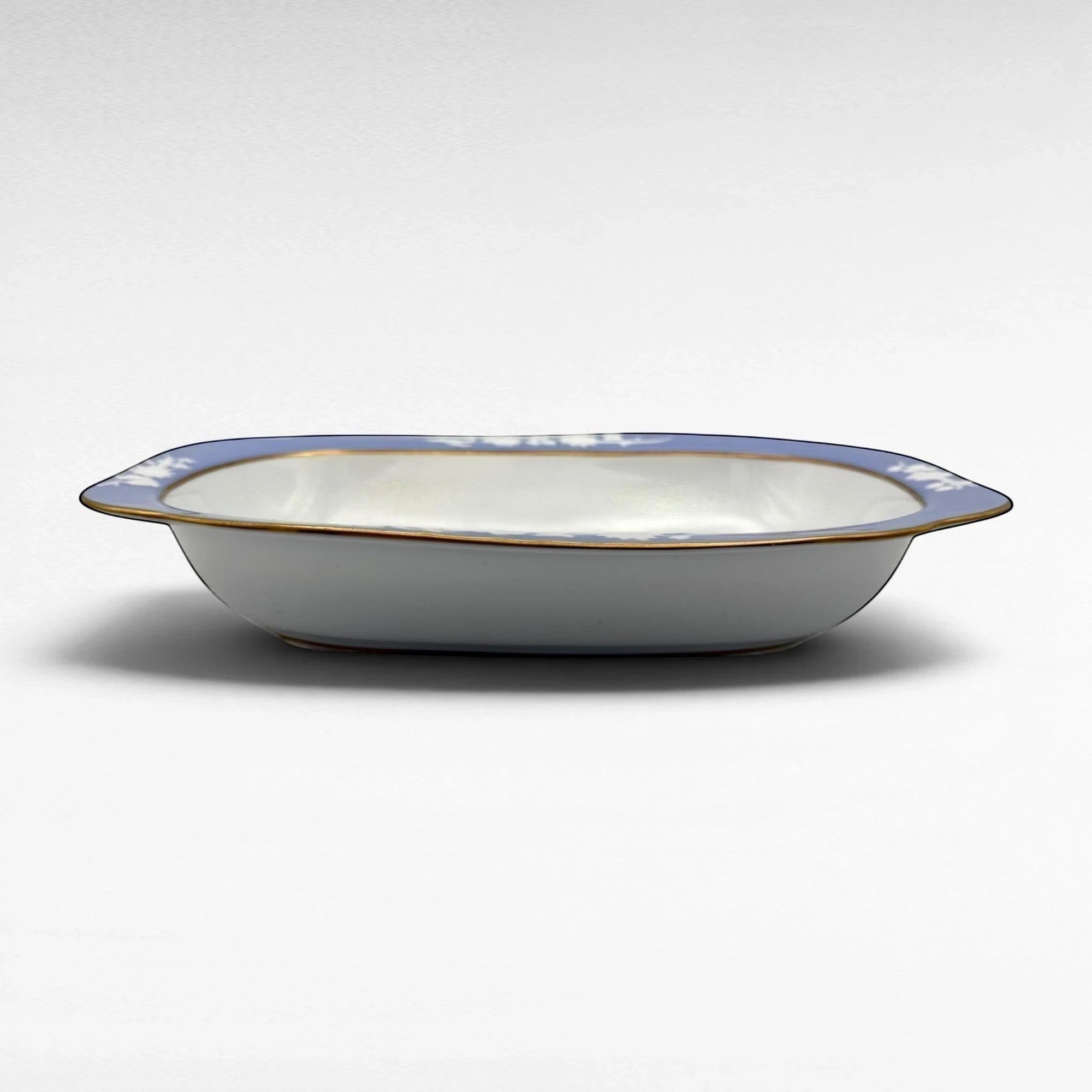The Brooklyn Teacup oval serving bowl with blue floral pattern, white interior, and gold rim detail.