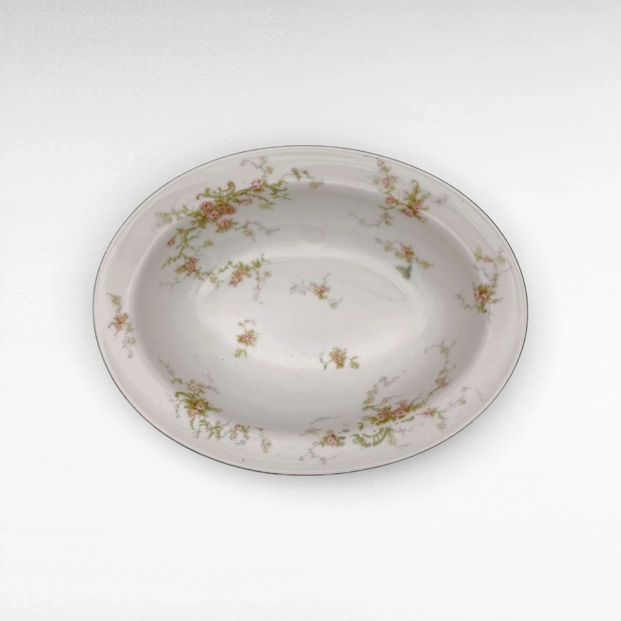 The Brooklyn Teacup oval serving bowl featuring delicate pink floral patterns on a white porcelain base.