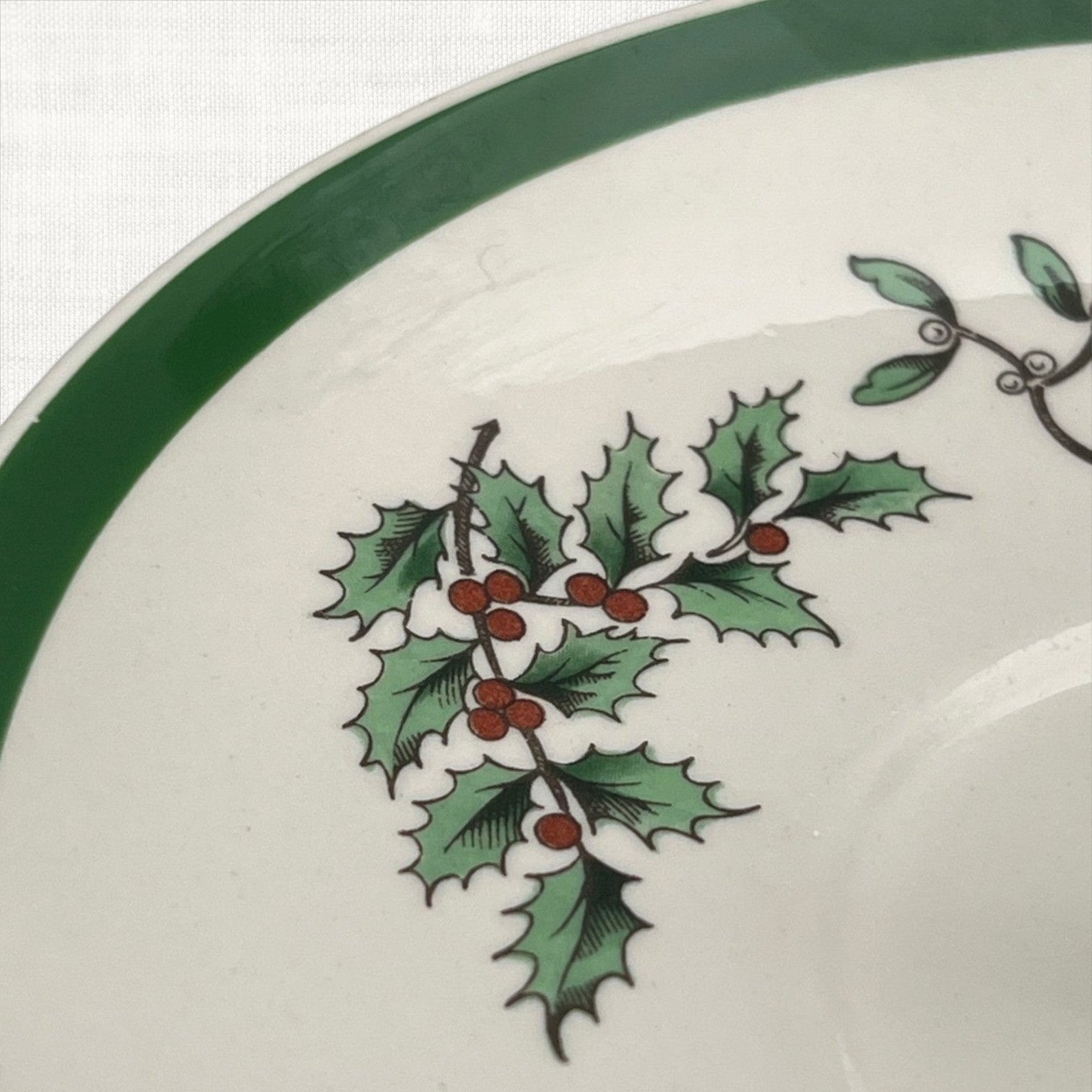 Spode Christmas Tree ceramic plate detail with green trim and holly sprig pattern