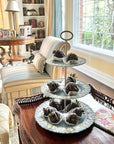 The Brooklyn Teacup custom three-tier tray made from light blue vintage china plates holding chocolate strawberries
