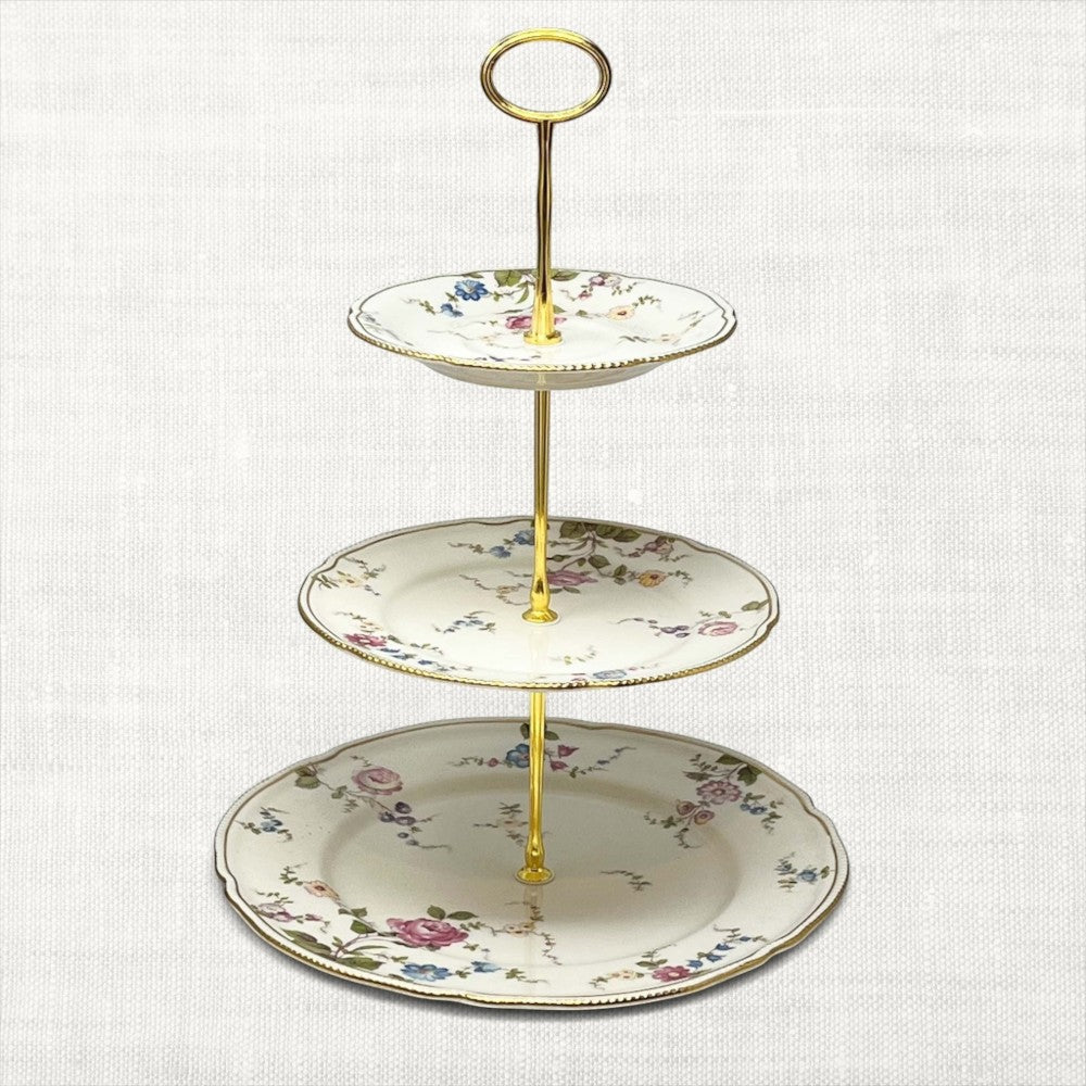 The Brooklyn Teacup custom three-tier serving tray made from vintage floral china plates with gold-tone hardware.