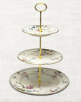 The Brooklyn Teacup custom three-tier serving tray made from vintage floral china plates with gold-tone hardware.