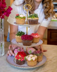The Brooklyn Teacup custom three-tier cupcake stand made from vintage china plates with gold hardware