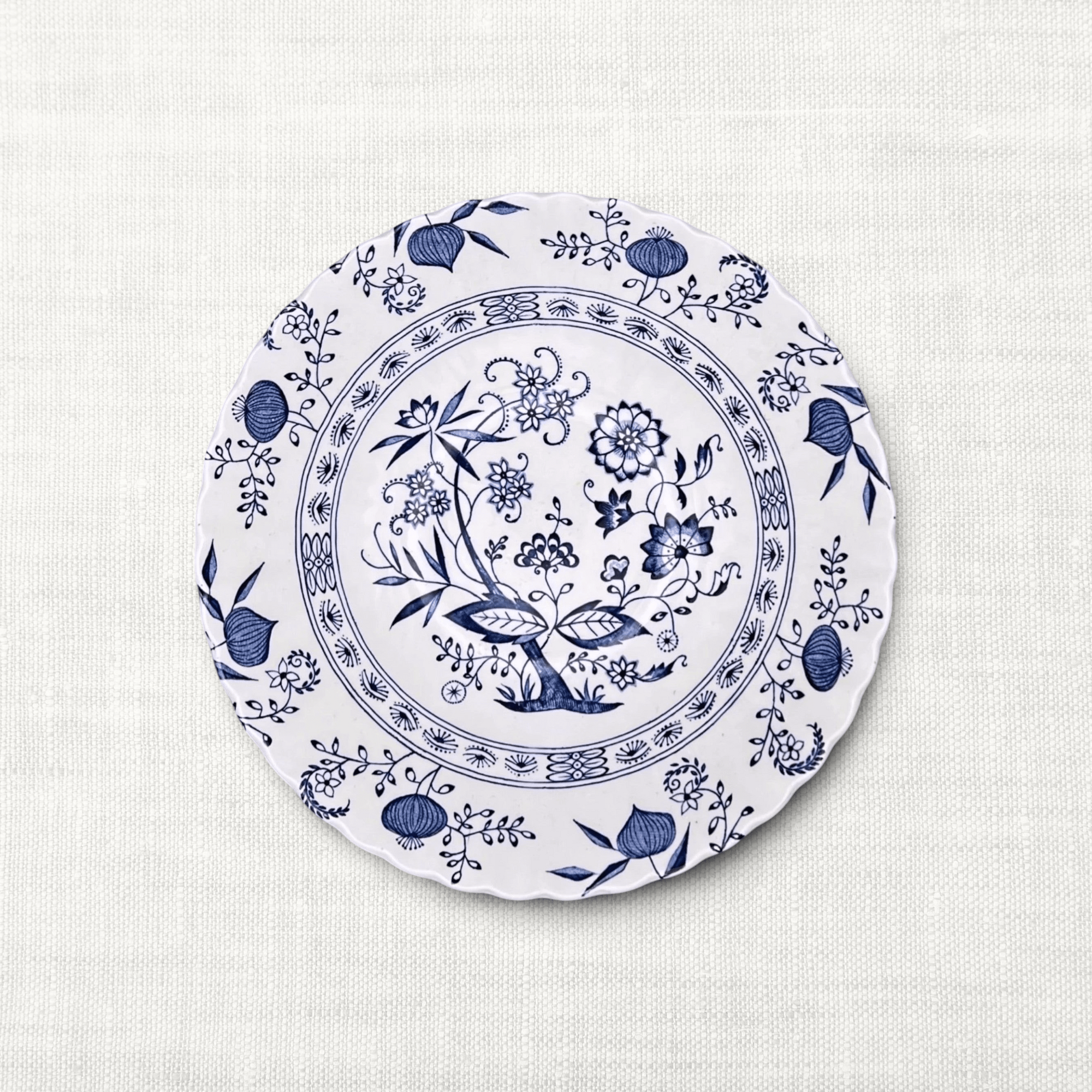 The Brooklyn Teacup vintage blue and white china bowl with intricate floral pattern and scalloped edge