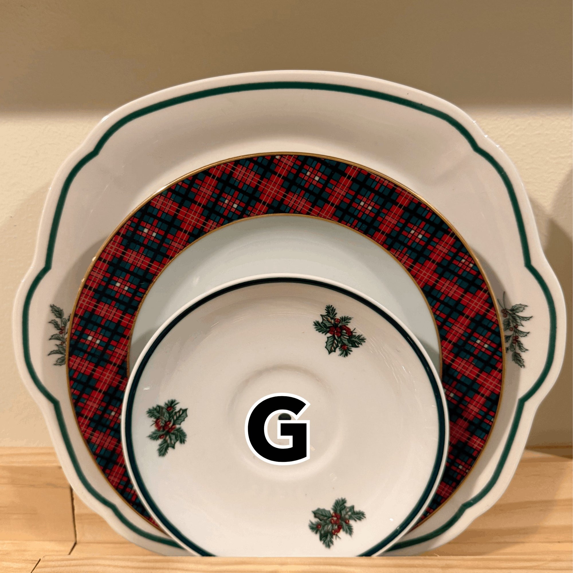 The Brooklyn Teacup vintage 3-tier Christmas tray set featuring festive plaid patterns and holly berry accents.