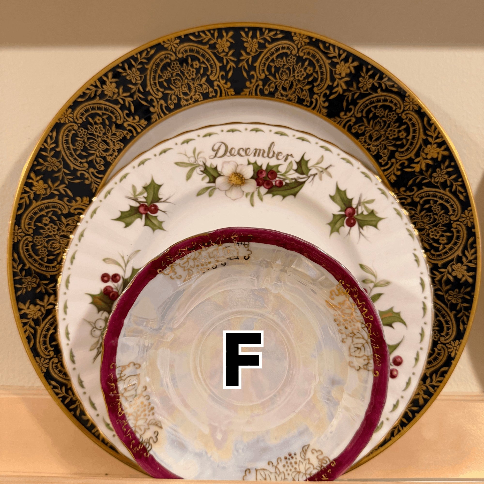 The Brooklyn Teacup vintage Christmas 3-tier tray featuring a December holly plate and ornate gold-rimmed china