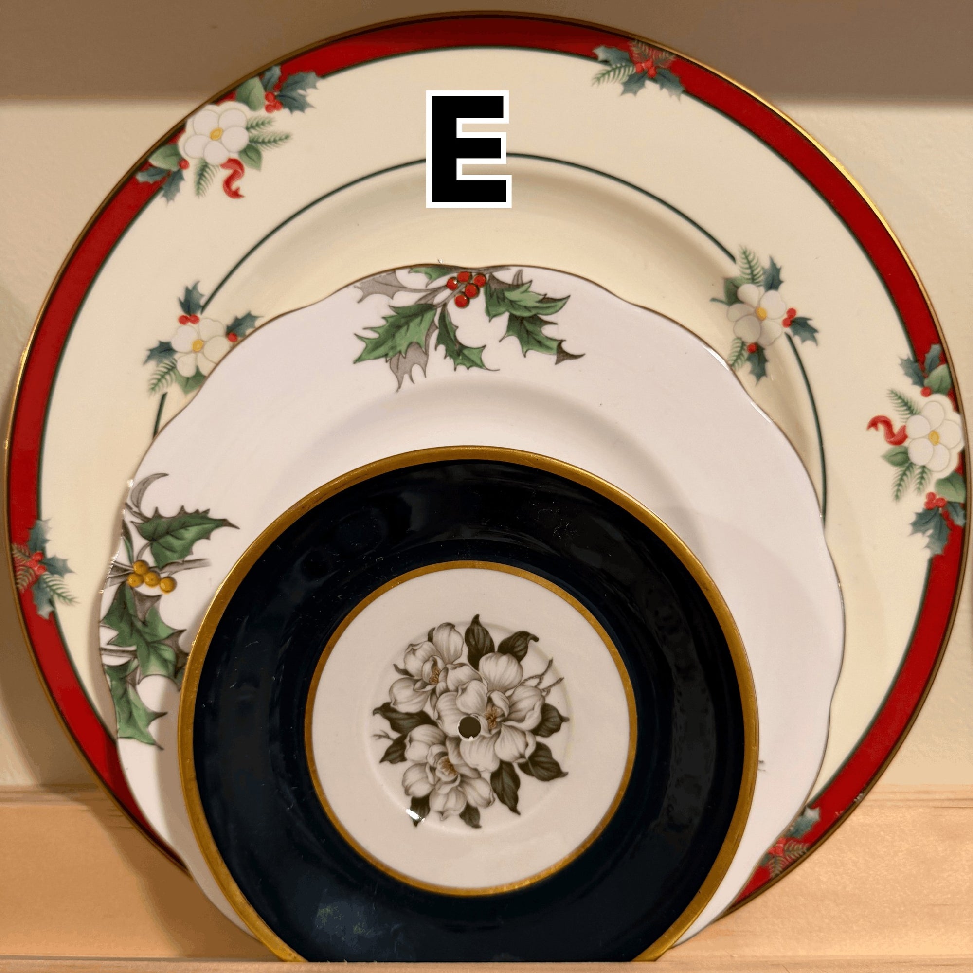 The Brooklyn Teacup vintage 3-tier Christmas tray plates featuring holly, magnolia, and gold rim details.