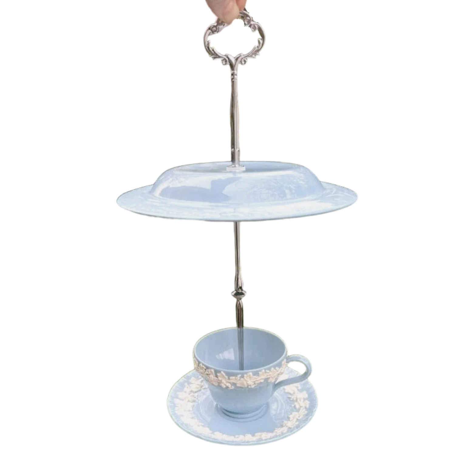 The Brooklyn Teacup Queensware bird feeder, a pale blue earthenware teacup and saucer with white floral detail, suspended from a silver stand.